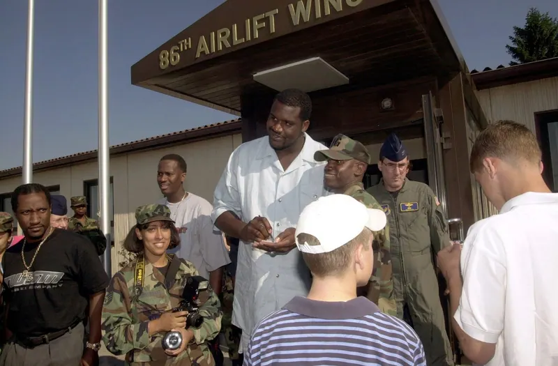 Shaquille O'Neal signs autographs for service members and families outside the 86th Airlift Wing building at Ramstein Air Base, Germany.