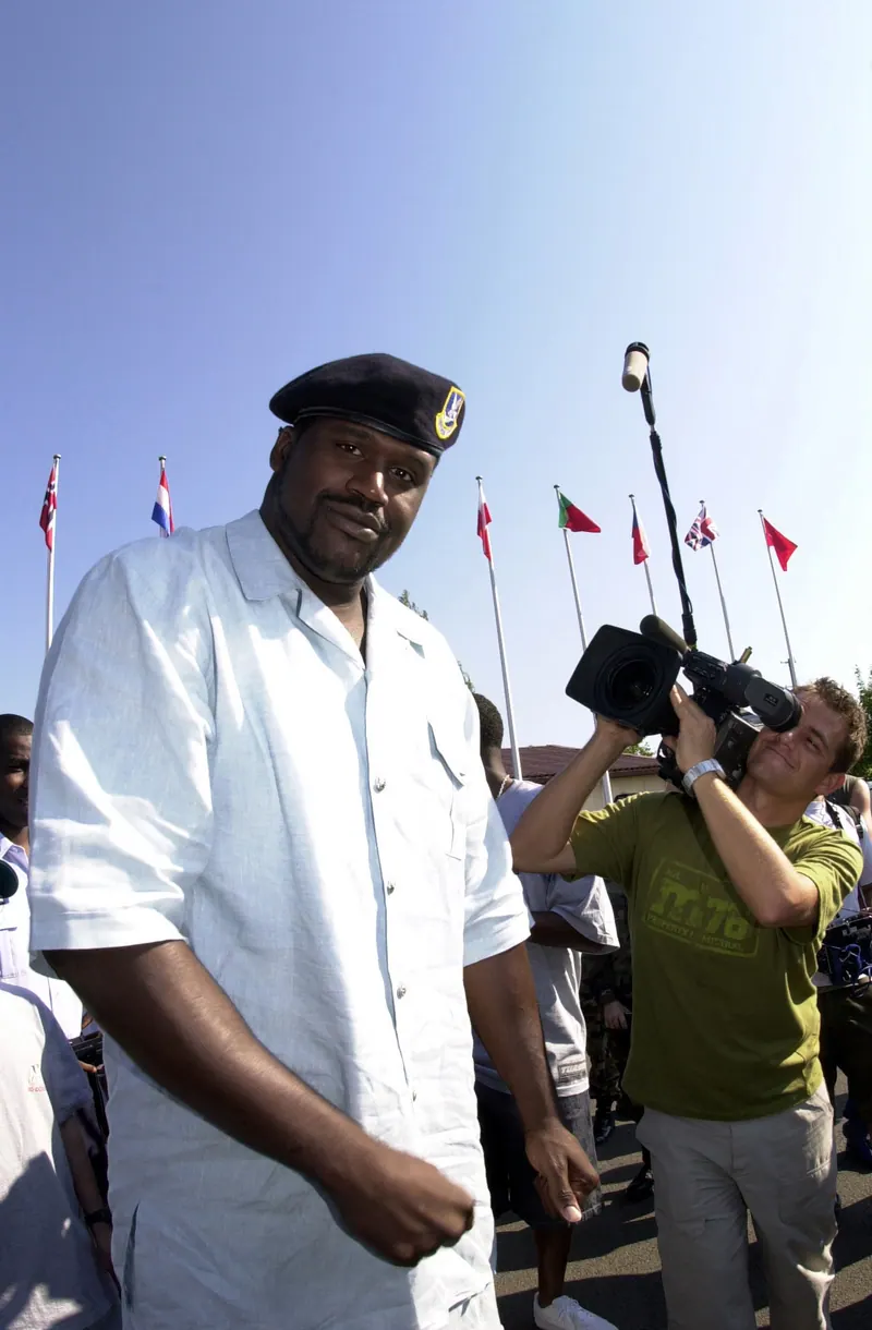 Shaquille O'Neal, then the Lakers' center, models a Security Forces beret given to him by an Airman of the 568th Security Forces Squadron during a visit to Ramstein Air Base, Germany.